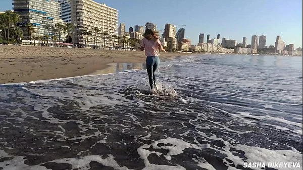 Wet shoot on a public beach with Crazy Model. Risky outdoor masturbation. Foot fetish. Pee in jeans.