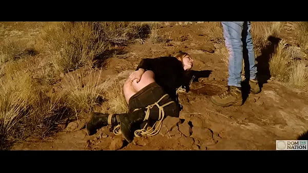 Big-ass blonde gets her asshole whipped, then gets rough anal sex in dirt and piss -- a real BDSM session outdoors in the Western USA with Rebel Rhyder