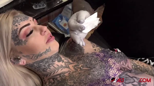 Sascha plays with Amber Luke while she gets tattooed