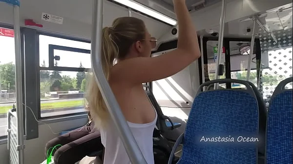 A girl rides a public bus with bare breasts